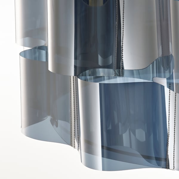 Modern metallic lamp with wavy design, reflecting light elegantly.