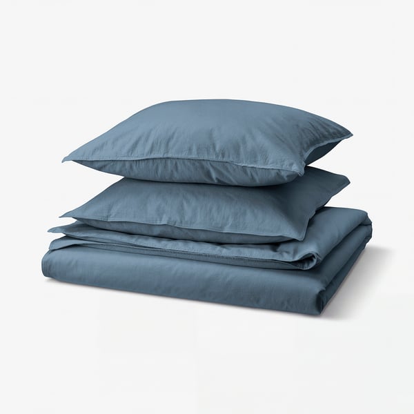Blue recycled cotton bedding set, folded neatly.