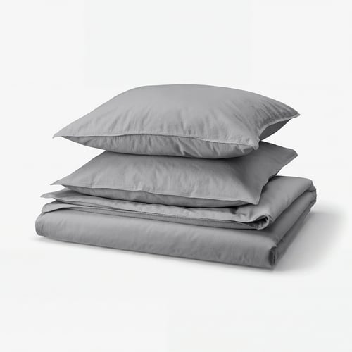 Grey cotton bedding set, including folded duvet and pillows, neatly stacked.