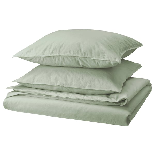 Soft green bedding stack: duvet & pillowcases, made from recycled cotton, neatly folded, fresh & casual design.