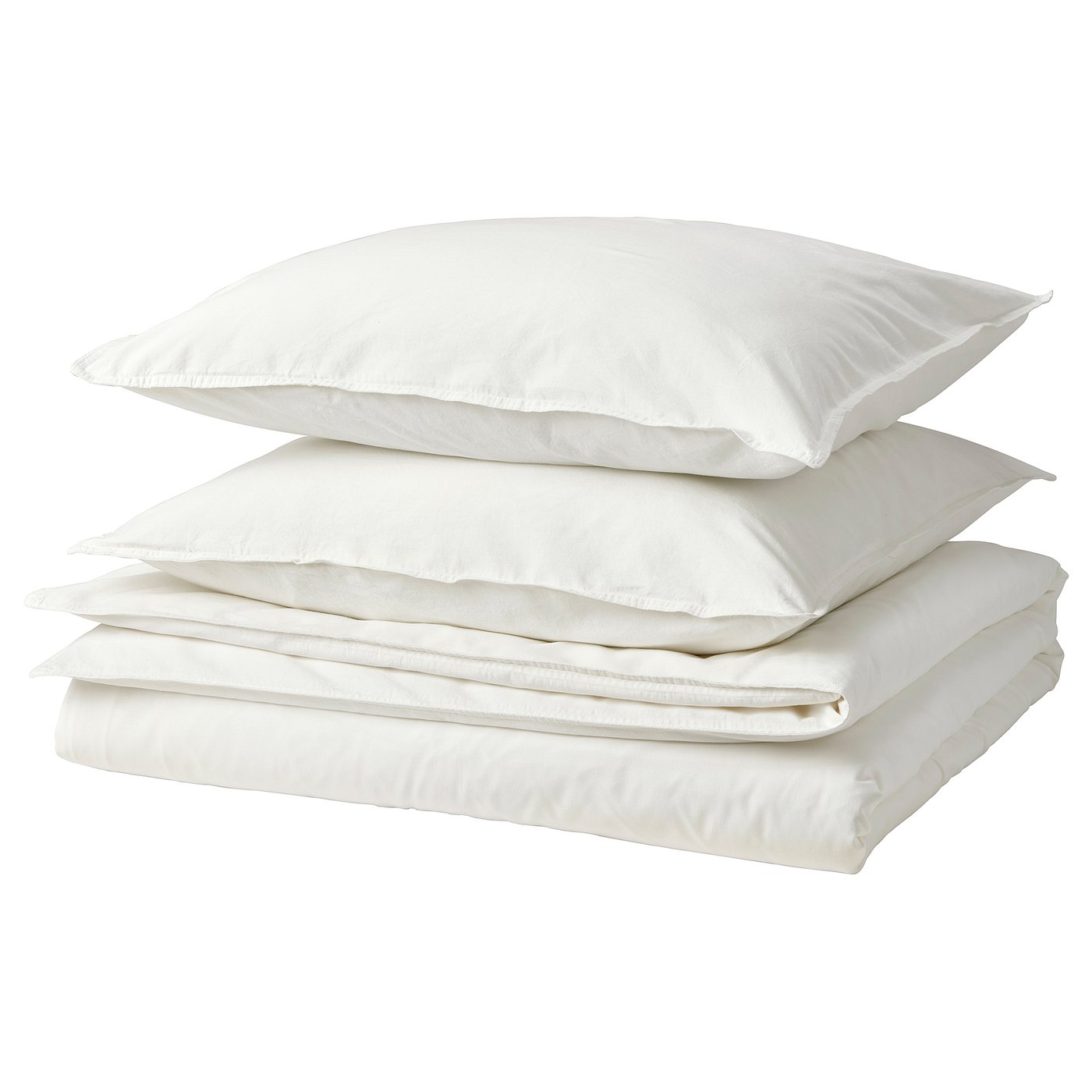 A stack of white cotton bed linens, including a duvet cover and pillowcases, arranged neatly.