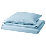A stack of light blue neatly arranged bed linens, including a duvet cover and two pillowcases, made from soft pre-washed cotton.