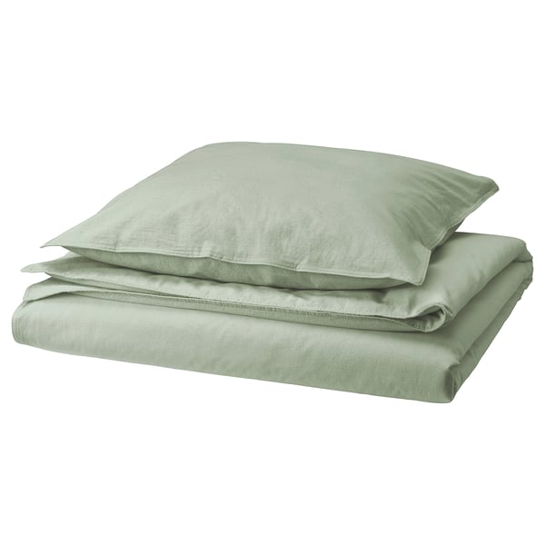 Light green folded bed linens, soft fabric, rectangular shape, basic design.