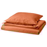 An ÄNGSLILJA orange bedding set, neatly folded. It includes a duvet cover and pillowcases made of soft, pre-washed cotton in a warm, earthy shade.