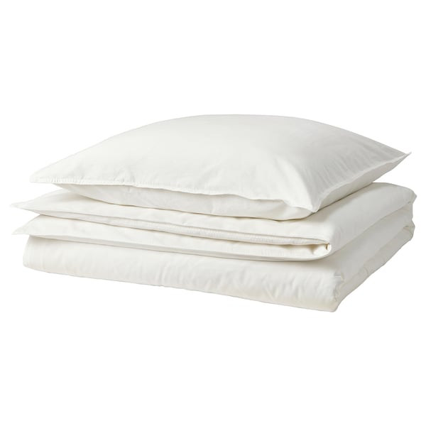 White bedding set. Three pillows and duvet stacked neatly. Soft, white cotton. Fresh and casual style.