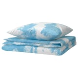 Light blue bedding set featuring sky and cloud pattern, folded neatly. Made of cotton and viscose, soft and cozy. Part of the nytillverkad collection.