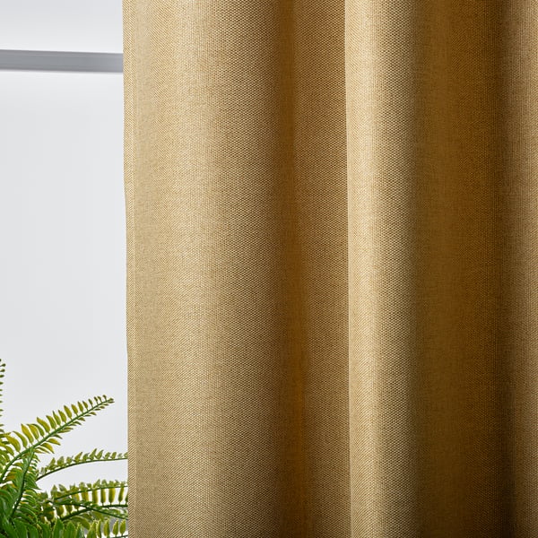 Curtains in gold weave block light, privacy guaranteed.