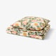 Floral duvet set: light beige with colourful flowers, soft cotton/lyocell blend, neat square stack.
