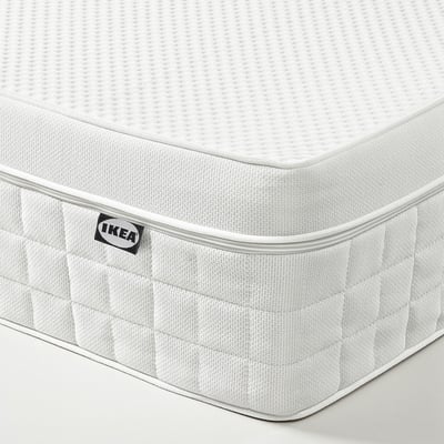 Close-up of ÅVABERG mattress, showcasing soft textures and ikea branding in corner.