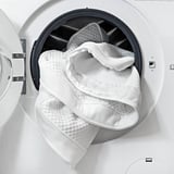 Washed mattress topper in dryer, showing easy-care feature.