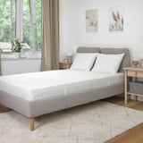 Modern bedroom with ÅVABERG bed, nightstands, and large window.