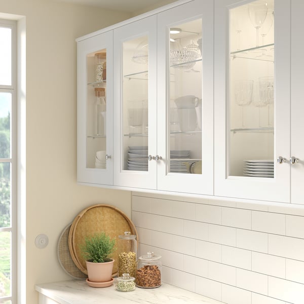 Glass cabinet doors, dishes, plant, stylish, modern.