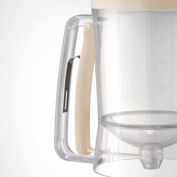 Transparent measuring jug with a beige comfort grip handle. Precise markings and a non-slip surface.