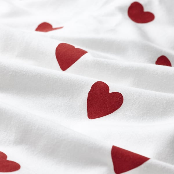 Soft red hearts on crisp white fabric; cozy and inviting.