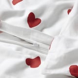 White duvet cover featuring red heart designs, with a visible zipper for easy use and flannel texture for warmth.