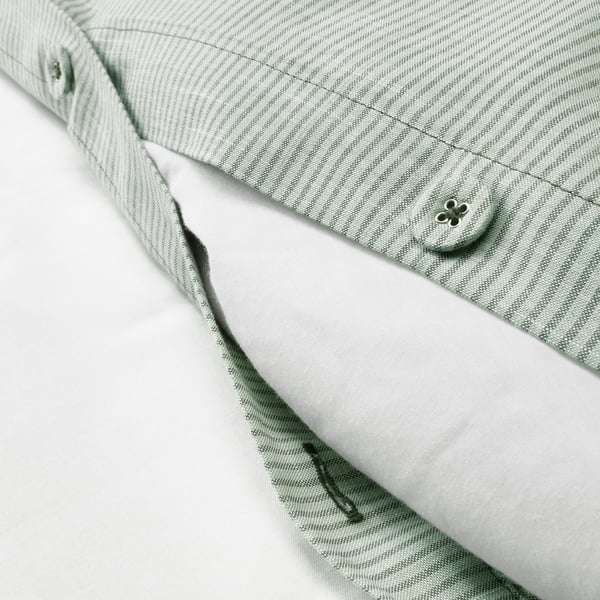 Close-up of duvet cover with button closure, soft cotton material.