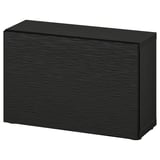 A black ikea BESTÅ storage unit. Its rectangular with a smooth dark wooden texture and flat top.