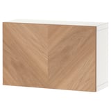 A white and light wood storage unit, part of the BESTÅ series, featuring a minimalist design with herringbone-patterned doors.