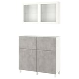 An ikea BESTÅ storage unit with concrete-effect grey doors and white wall cabinets. It includes shelves and drawers for versatile storage.