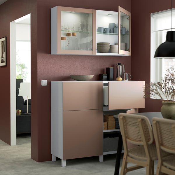 Modern kitchen featuring BESTÅ storage with glass doors showcasing mugs and bowls; wall-mounted cabinets provide additional storage.