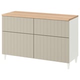 This image shows a BESTÅ sideboard in beige and oak, featuring four doors and two drawers for storage, with white legs.