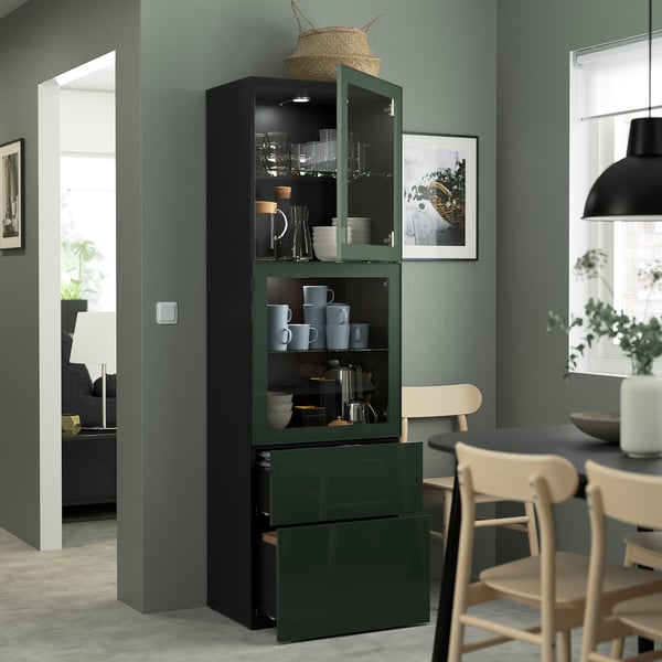 Modern glass-door cabinet displays dishes and mugs. Household items are stored in both open and enclosed sections.
