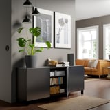 Modern living room with BESTÅ storage, plant, and photos.