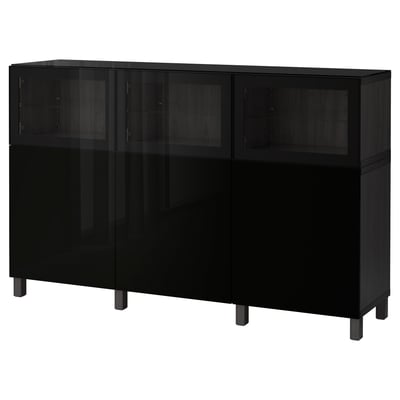 Black BESTÅ cabinet, modern design with glass doors and wooden legs.