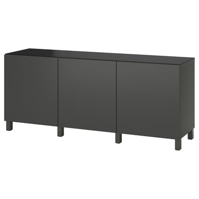 A black ikea BESTÅ sideboard with three doors and tapered legs.
