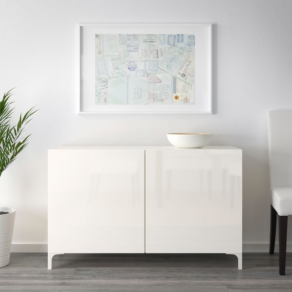 White sideboard with soft closing doors. Bowl on top, art above.