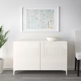 White sideboard with soft closing doors. Bowl on top, art above.