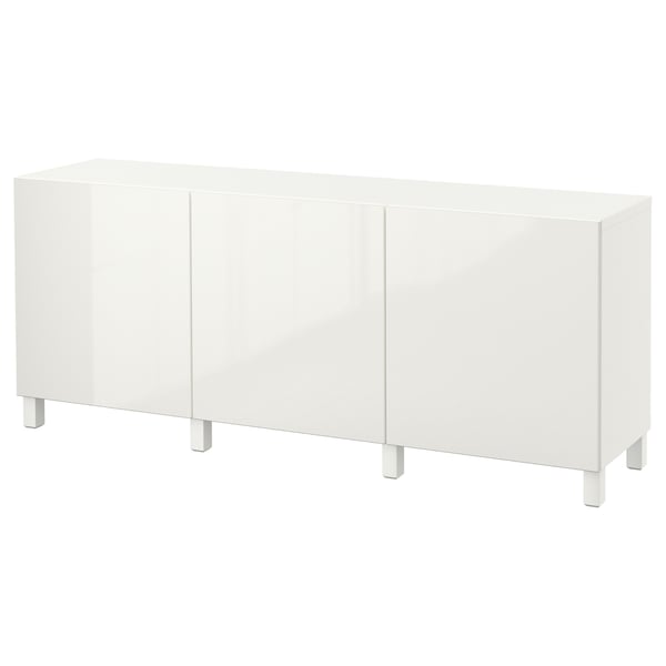 A white BESTÅ sideboard. Its sleek and rectangular with four legs and two large doors for storage.