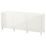 A white BESTÅ sideboard. Its sleek and rectangular with four legs and two large doors for storage.