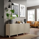 Ikea BESTÅ sideboard in white, rectangular with 2 doors, adjustable shelves, house plant, 2 photos, mid-sized, fits under large windows.