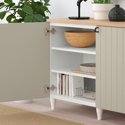 Eral sideboard with shelves, bowl, books, fabric basket, and potted plants.