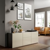 Modern living room with BESTÅ sideboard, vase, photos, orange sofa, and large windows.