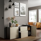 Modern living room with BESTÅ unit showing books, bowl, flowers, and open storage.