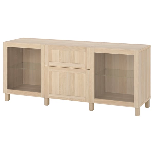 Light oak BESTÅ storage set with shelves, drawers, and glass doors.