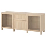 Light oak BESTÅ storage set with shelves, drawers, and glass doors.