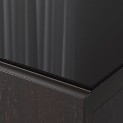 Black glass top panel corner, showing sleek, shiny edge, seamless design.