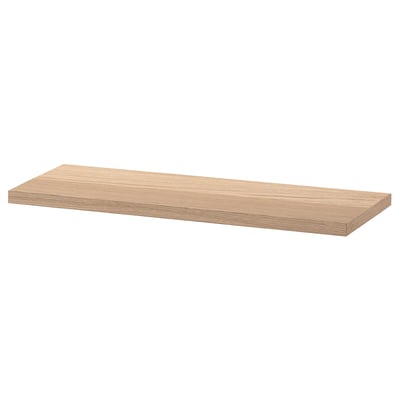 An ikea BESTÅ wooden shelf with a smooth, light oak finish. Its rectangular shape is perfect for storage and display.