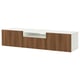 A white and wood grain BESTÅ tv bench with drawers and a central open space for cable management.