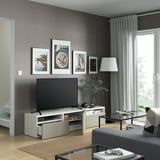 Modern living room with BESTÅ tv bench, featuring sleek design, adjustable feet, cable management, and storage drawers.