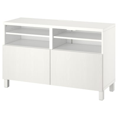 An ikea BESTÅ white tv bench with adjustable shelves and closed cabinets for storage.