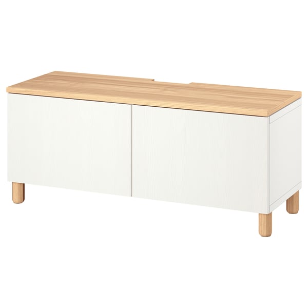 White BESTÅ tv bench with oak top, legs, and soft-close doors. Rectangular, minimalist design for cable management.