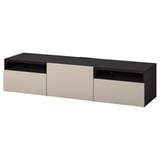 A black and beige BESTÅ tv bench with three compartments and a sleek, modern design.