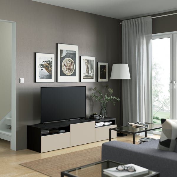 Modern living room with BESTÅ tv unit, flat-screen tv, lamp, and glass coffee table.