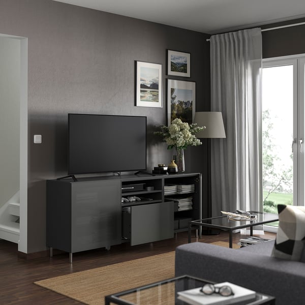 Modern living room with BESTÅ dark grey tv bench, flat screen, decor, and large window.
