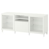 White BESTÅ tv bench with glass doors, adjustable shelves, and wooden legs.