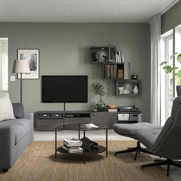 Modern living room with BESTÅ tv bench, sofa, coffee table, & record player. Gray walls, shelves, large window.